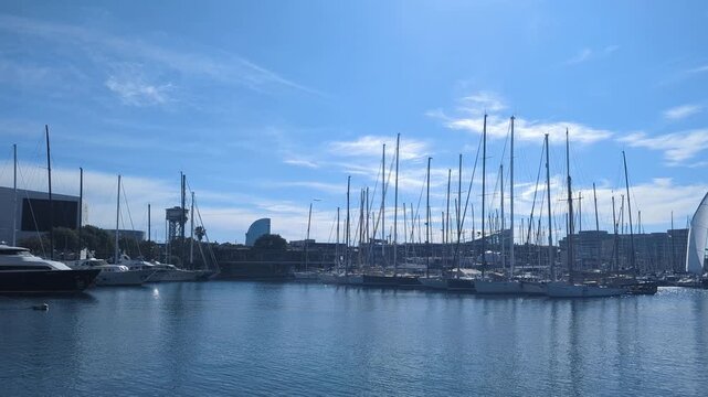 Barcelona. Scenic view of harbor with sailboats and vibrant blue sky showcasing tranquility of waterfront life and nautical beauty in city harbor
