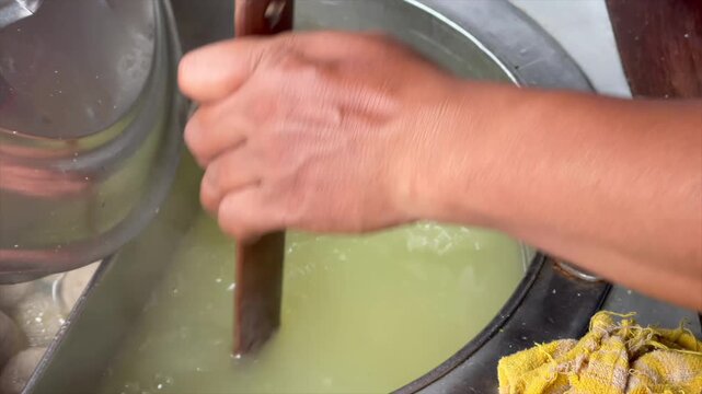 Street food vendor boiling noodles for indonesian chicken noodle and meatball soup.