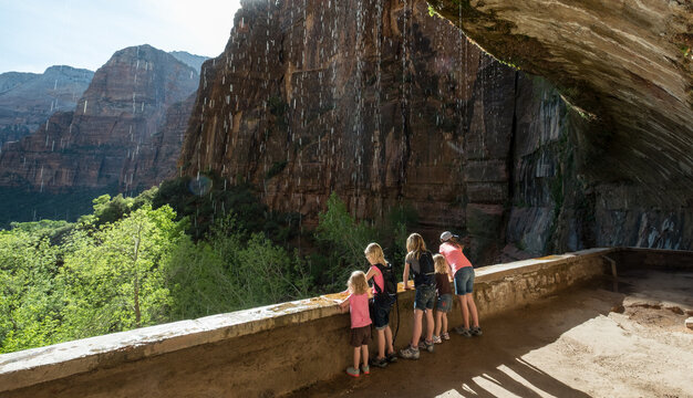 Family Observe Nature at Weeping Rock Overlook in Zion National Park Utah