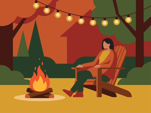 A woman relaxes by a glowing fire pit on a cool evening, enjoying a peaceful moment outdoors. Warm lighting and autumn colors create a cozy atmosphere.