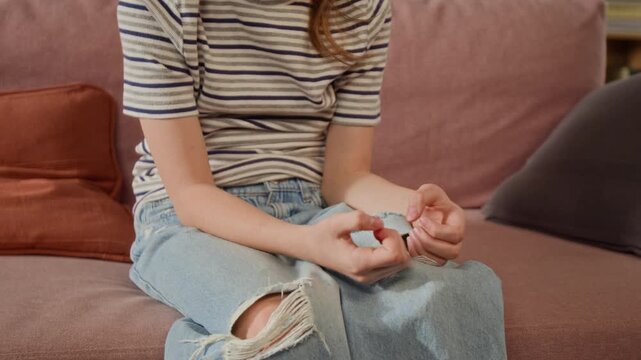 Tilt up shot of girl child fidgeting with fingers while sharing feelings with therapist during supportive session for developmental challenges in preteen years