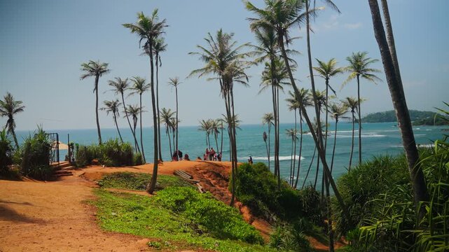 Turqouise ocean waves surrounding Coconut Tree Hill, Sri Lanka