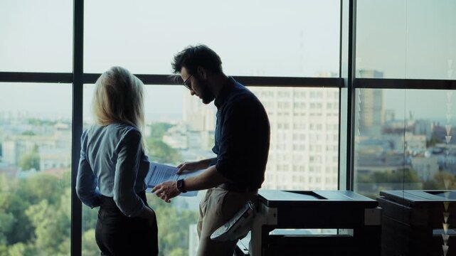 Business Partners Discussing Documents. Analyzing Reports In Modern Workspace. Corporate Teamwork. Office Life