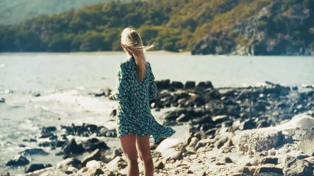 Traveler Standing on Rocky Shoreline near Sea. Tourist Enjoying Scenic Ocean View and Summer Breeze. Peaceful Adventure. Serene Relaxation