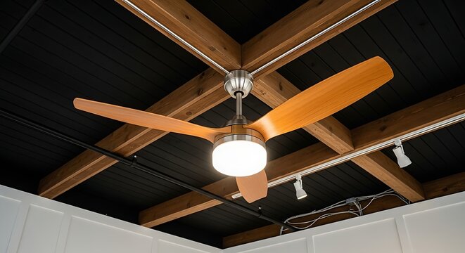 Modern wooden ceiling fan with light fixture mounted on exposed dark wood beams