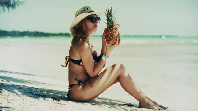 Traveler Posing With Fresh Pineapple On Tropical Beach Sand. Relaxing Island Getaway. Mood During Travel Journey
