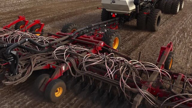 Aerial Drone Footage of Tractor Seeding Prairie Farmland During Spring Planting