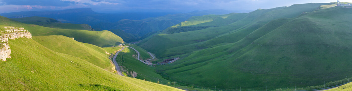 Scenery of green mountain slopes at summer travel in the evening sunlight