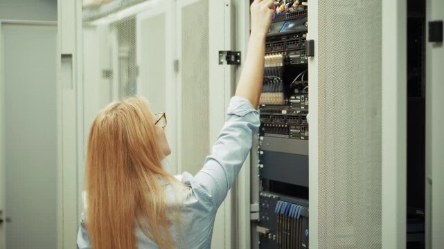 IT Engineer Connecting Network Cables In Server Rack. System Administrator Troubleshooting Connection