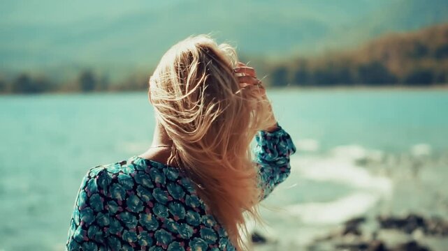 Tourist Looking at Turquoise Water and Misty Hills. Wandering Inspiration and Solitude During Vacation Trip