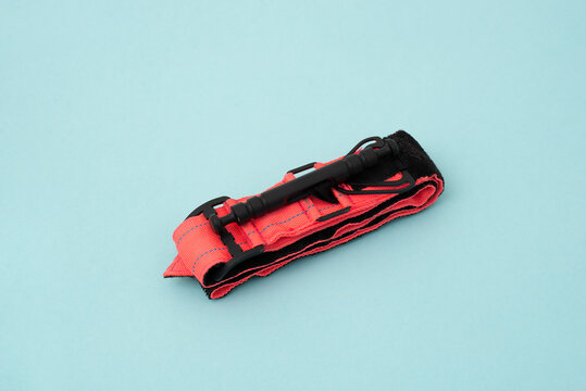 tactical tourniquet for emergency medical first aid and bleeding control on a blue background