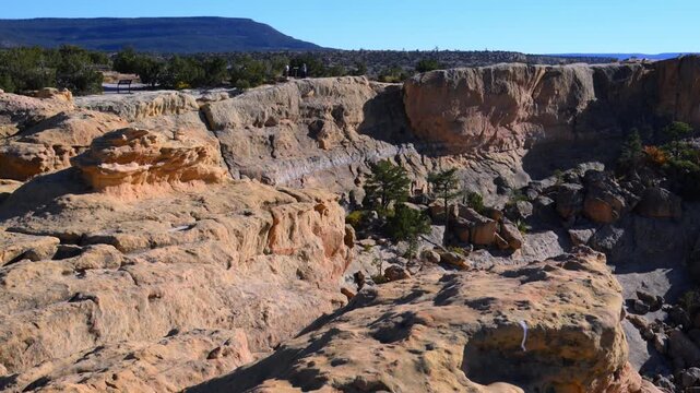 Sandstone cliffs with drought-tolerant coniferous vegetation at the margin of a lava valley in El Malpais National Monument