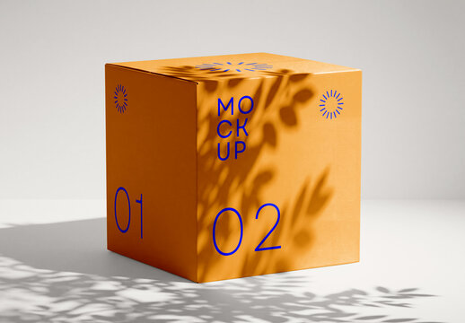 Square Orange Cardboard Box Mockup with Natural Leaf Shadow Overlay on White Editable Background for Product Branding Design Showcase