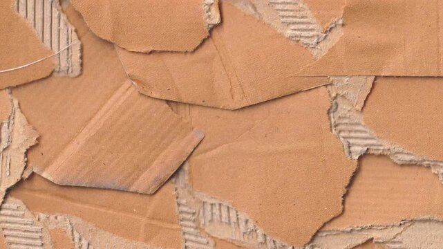 Animated torn cardboard texture background featuring realistic ripped edges layered corrugated paper and organic craft aesthetic for industrial video overlays and creative projects.
