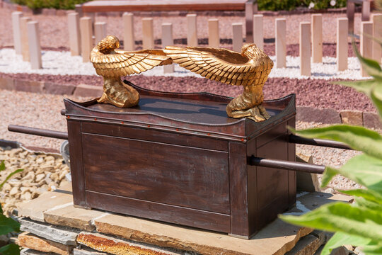 Model of the Ark of the Covenant with golden cherubim on the lid outdoors.