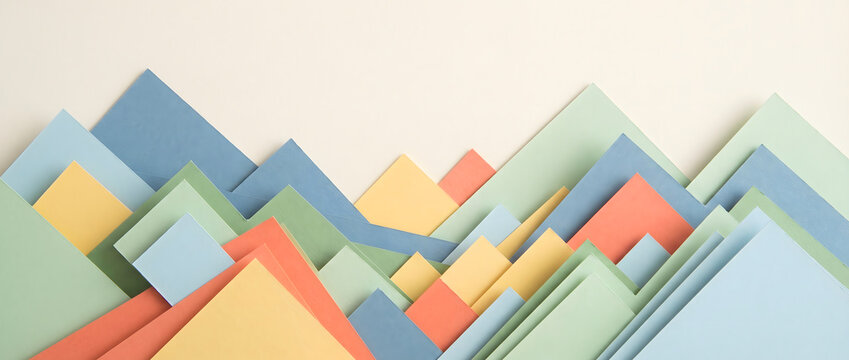 Colorful paper sheets layered to form geometric mountain-shaped patterns