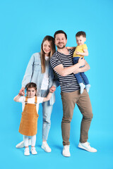 Obraz premium Portrait of happy family on light blue background