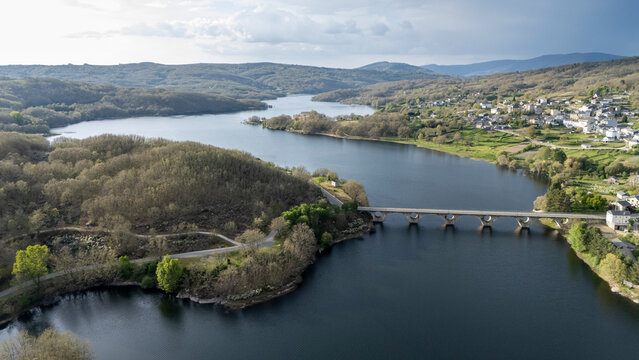 Encoro de prada reservoir with bridge and village