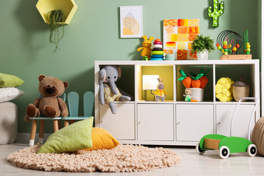 Shelving unit with toys in child's room. Interior design