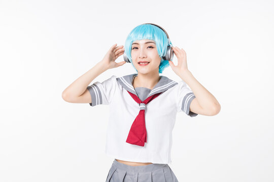 Smiling anime cosplay student listening to music with headphones