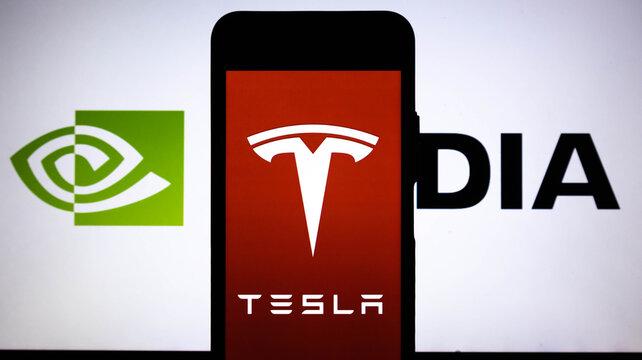 Tesla logo on a smartphone screen displayed in front of the nvidia logo concept of technology giants, stock market, electric vehicles and artificial intelligence