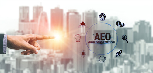 Naklejka premium Hand Reaching Towards AEO Concept with Urban City Background and Digital Elements Representing Answer Engine Optimization Strategies Fluxor.
