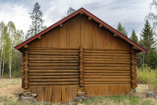 Detailes of an old log house stands on stone piles. Traditional Scandinavian and Norwegian architecture.