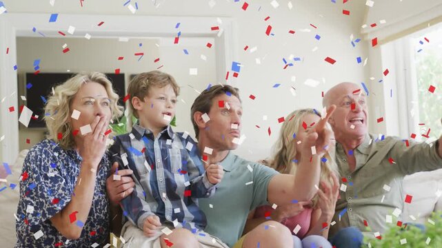 Family sitting on couch, woman pressing remote, confetti falling, group cheering for entertainment