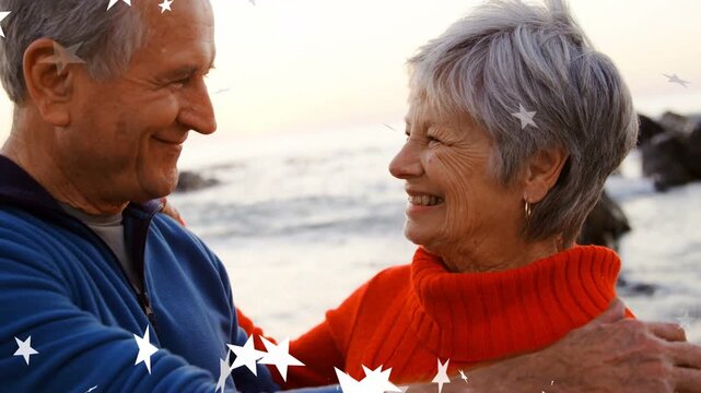 Senior couple exchanging smiles sparking hug, star graphics drifting across foreground for health