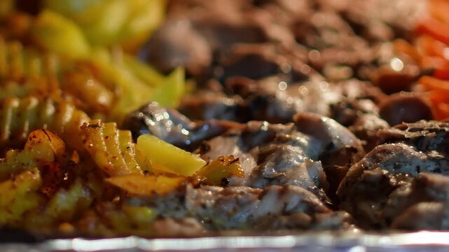 A stunning close-up of roasting vegetables inside the oven for a Sunday roast. Carrots, beetroot, onion, parsley root, celery, broccoli, sweet potato, and chicken fillet. A wholesome family meal