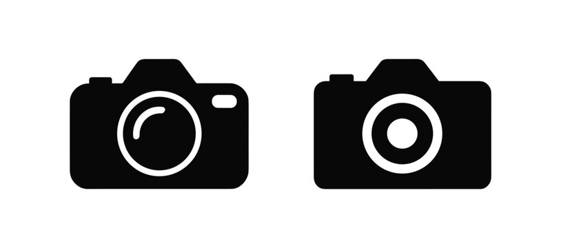 Two black silhouette of digital cameras with lens details isolated on a white background showing different lens aperture for and media interface symbols