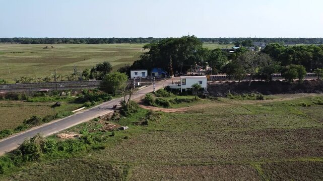 Cinematic Drone Shot of a Small Railway Station and Level Crossing in Odisha Countryside.