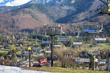 ZAKOPANE, POLAND - APRIL 25, 2026: A chairlift on Polana Szymoszkowa closed after the season, surrounded by views of the Tatra Mountains. © agneskantaruk