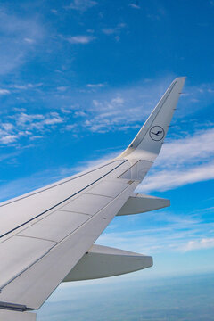 En route London to Frankfurt - 11 April 2026: Curved tip winglet of an Airbus A320 Neo jet operated by Lufthansa isolated against a blue sky