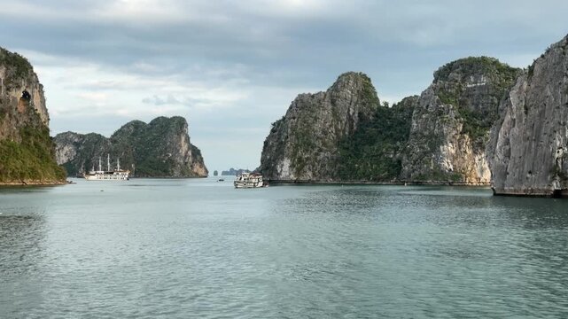 scenic cruise tour through emerald waters of halong bay vietnam with limestone karst islands, travel destination, majestic seascape, serene nature, outdoor adventure, tourism exploration