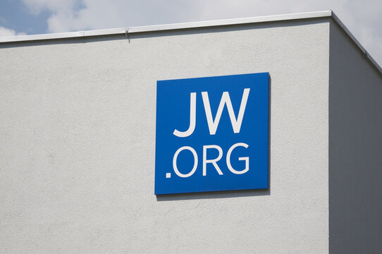 Jehovah's Witnesses (JW.org) sign logo on building exterior in Bellinzona, Switzerland