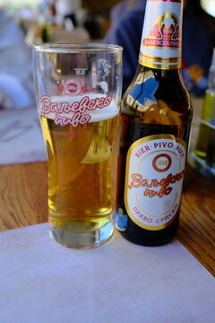 Valjevo, Serbia &ndash; April 4, 2026 &ndash; Valjevsko pivo beer bottle close-up on table with a glass with beer