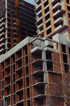 The facade of a new high-rise building under construction. The building has no windows and no exterior cladding.