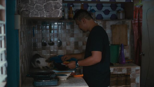 Filipino man cooking a simple meal in the kitchen