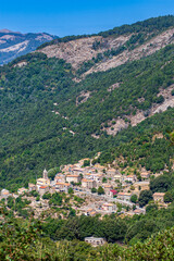 Obraz premium Typical hilltop village Cristinacce, a hillside town nestled in the mountains, a commune in the Corse-du-Sud on the island of Corsica, France. The village in its green setting in the Tavulella valley.