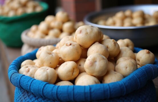 Dried potatoes called chuno pile in woven baskets at outdoor market. These tubers are ancient Andean food staple. They have long shelf life and nutritional value. A source of food for many.