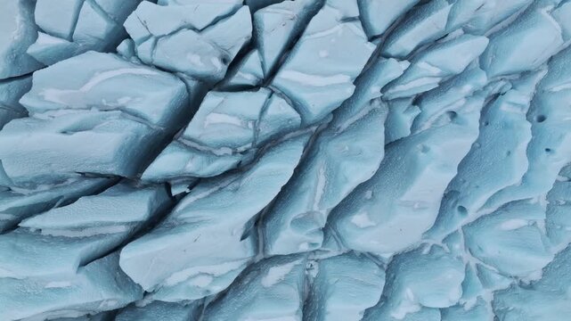 Aerial view of the deep blue crevasses and textured ice formations of the Jokulsarlon glacier in Sveitarfelagid Hornafjordur, Iceland.