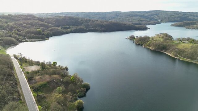 Aerial view of prada reservoir surrounded by forest and road