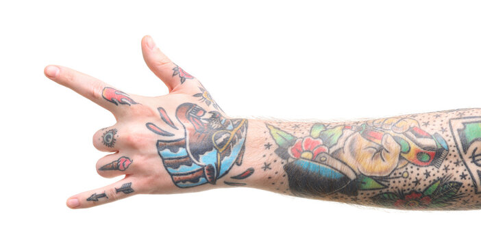Man with tattoos showing rock gesture on white background, closeup