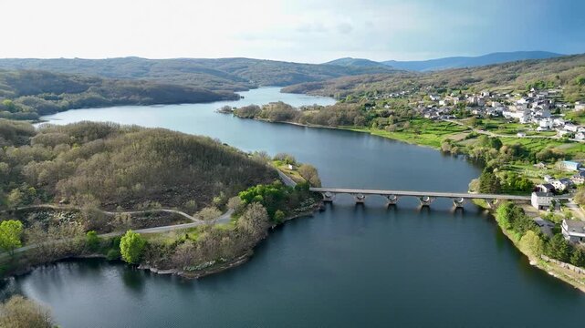 Aerial view flying over prada reservoir bridge in spain