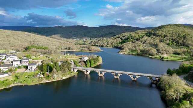 Aerial view flying over prada reservoir bridge in galicia
