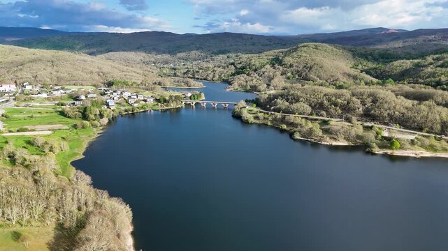 Drone flying towards stone bridge over prada reservoir