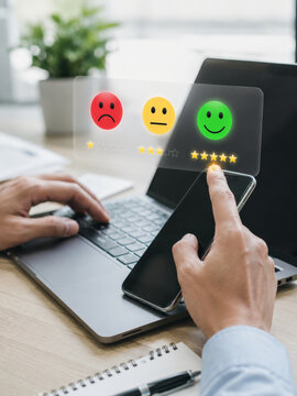 Customer feedback rating review laptop with hand holding smartphone, positive satisfaction