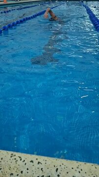 man swimming in pool