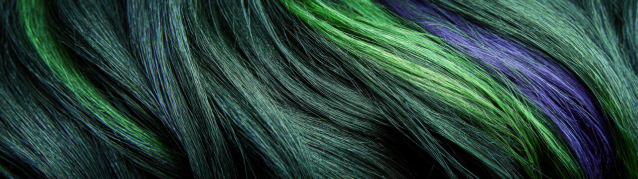 Vibrant streaks of emerald green and deep violet flow through dark strands in Aurora Australis Tresses, creating a silky, luminous texture that mimics the shifting colors of the southern lights